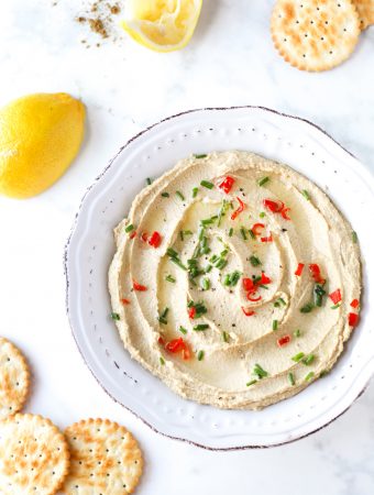 Hummus sprinkled with herbs and chilli