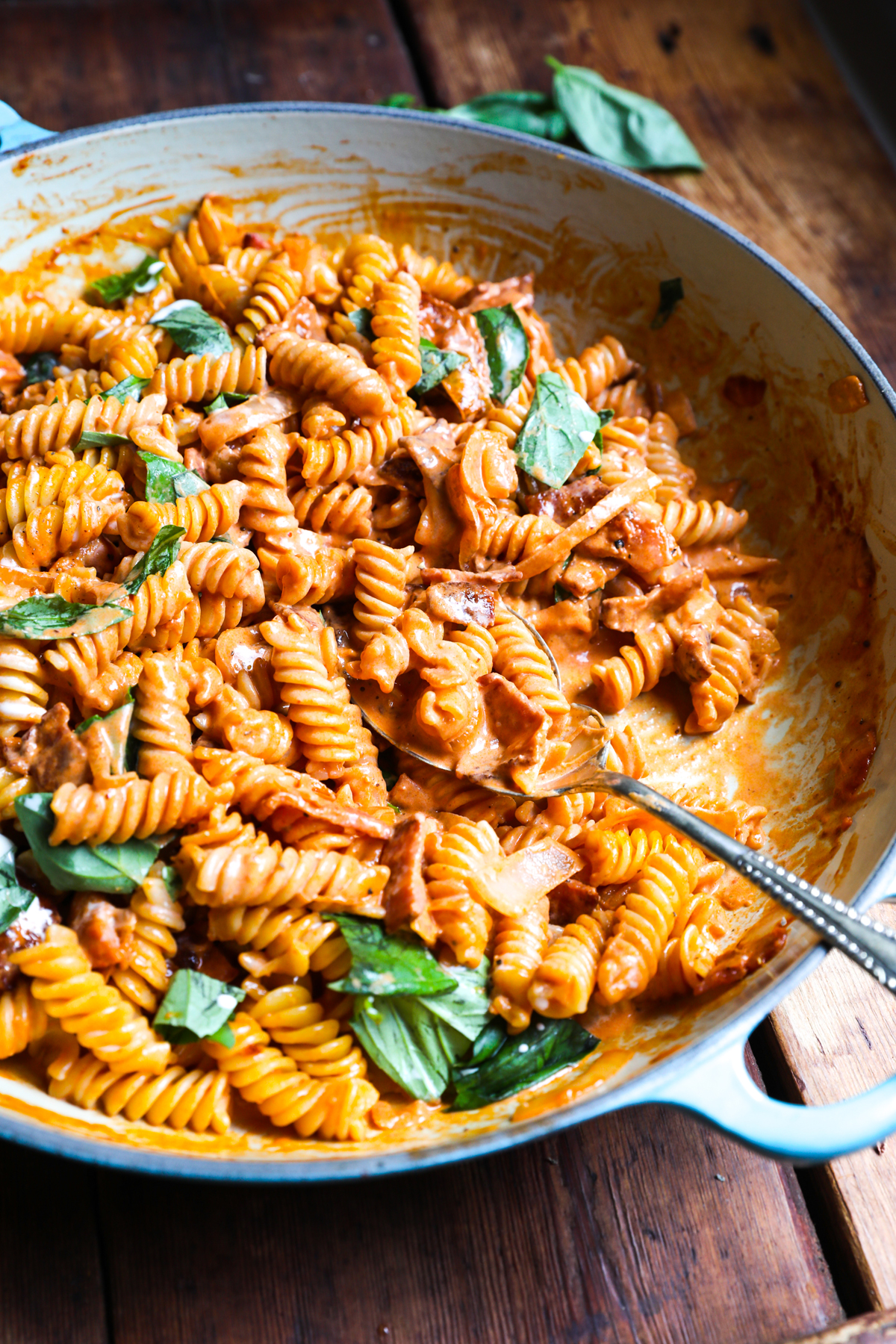 creamy tomato and bacon pasta in pan 